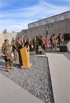 Maj. Richard Zeigler (podium), 451st Expeditionary Security Forces Squadron commander, addresses his unit during a deactivation ceremony at Camp Losano, Kandahar Airfield, Afghanistan, Dec. 27, 2013. (U.S. Air Force photo by Capt. Jason Smith)