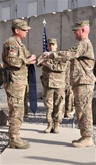 Col. Sean Tyler (left), 451st Expeditionary Mission Support Group commander, and Maj. Richard Zeigler (right), 451st Expeditionary Security Forces Squadron commander, case the squadron guidon during the 451st ESFS deactivation ceremony at Camp Losano, Kandahar Airfield, Afghanistan, Dec. 27, 2013. (U.S. Air Force photo by Capt. Jason Smith)